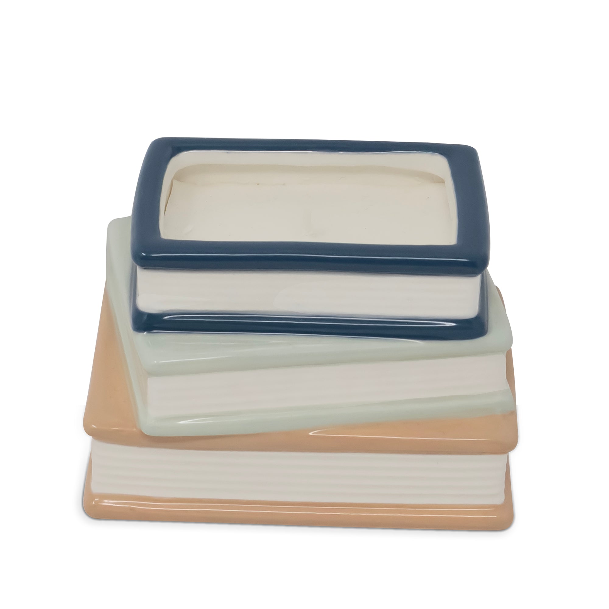 A ceramic stack of three books with a small rectangular box on top, photographed on a clean white background.