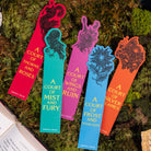 Colorful bookmarks with book titles on a textured green background