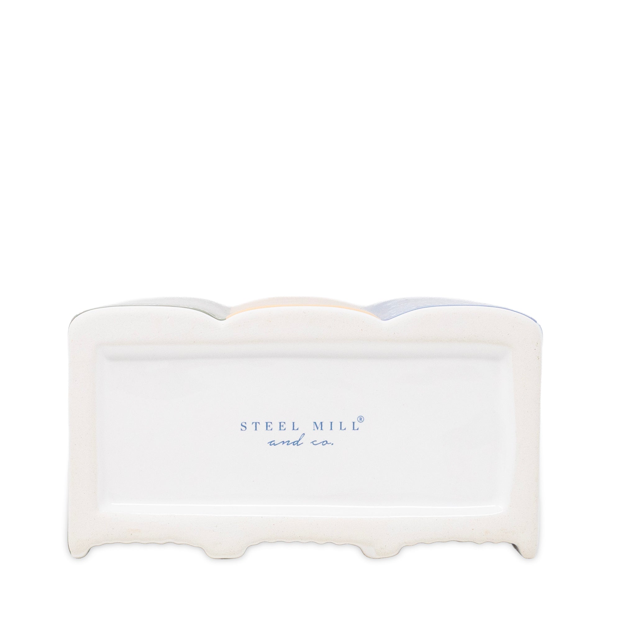 A white ceramic napkin holder with a scalloped rim and the brand name 'STEEL MILL and co.' printed in blue on the front, set against a plain white background.