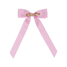 A light pink satin bow hair clip with a gold metal bar clasp, shown against a plain white background.