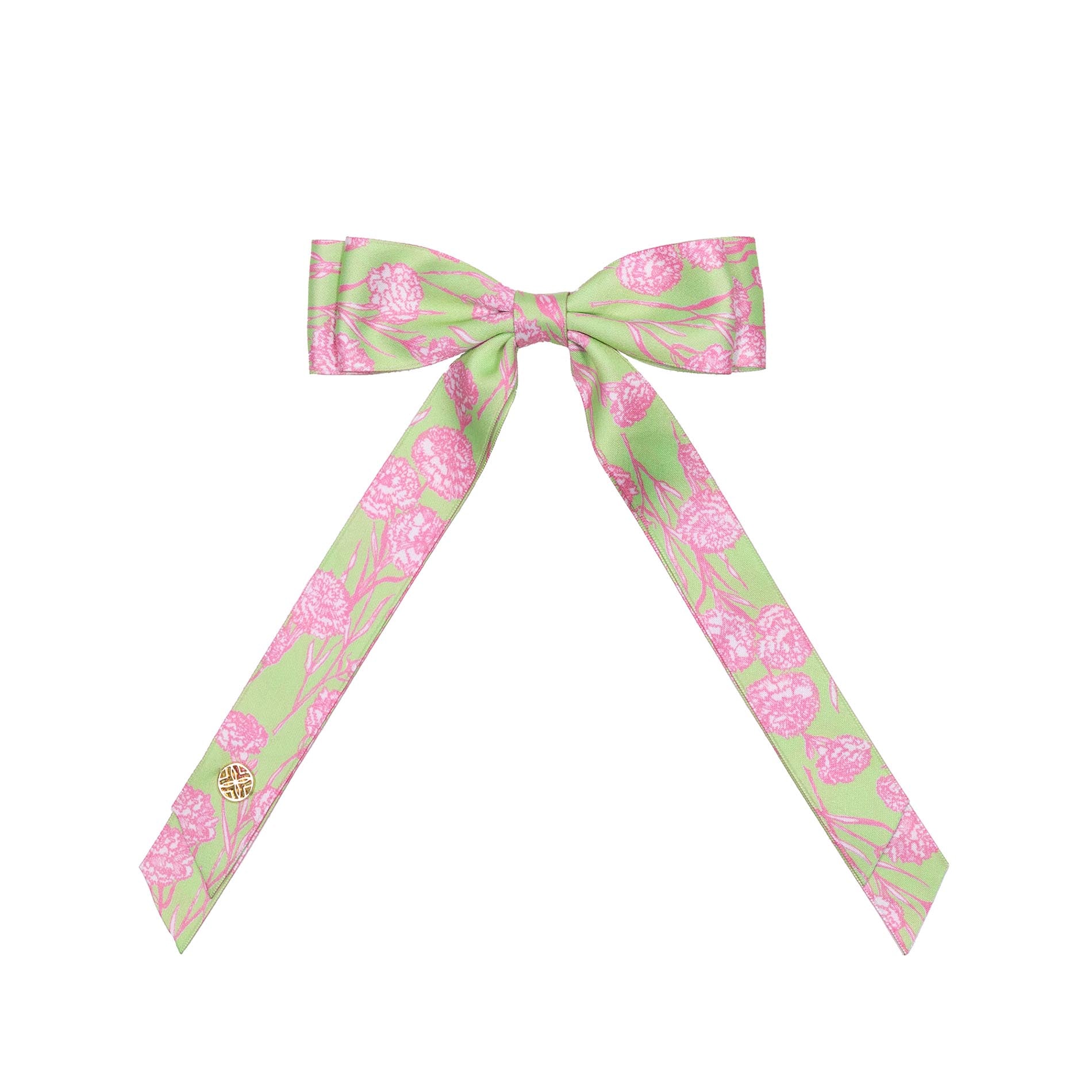 Green and pink patterned bow on a white background
