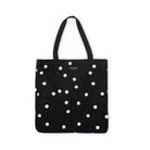 black canvas book tote with black and white polka dot print