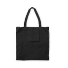 interior of black canvas book tote with black and white polka dot print