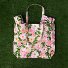 Floral patterned tote bag on a green textured background