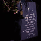 side view of Navy tote bag with white text and star graphics