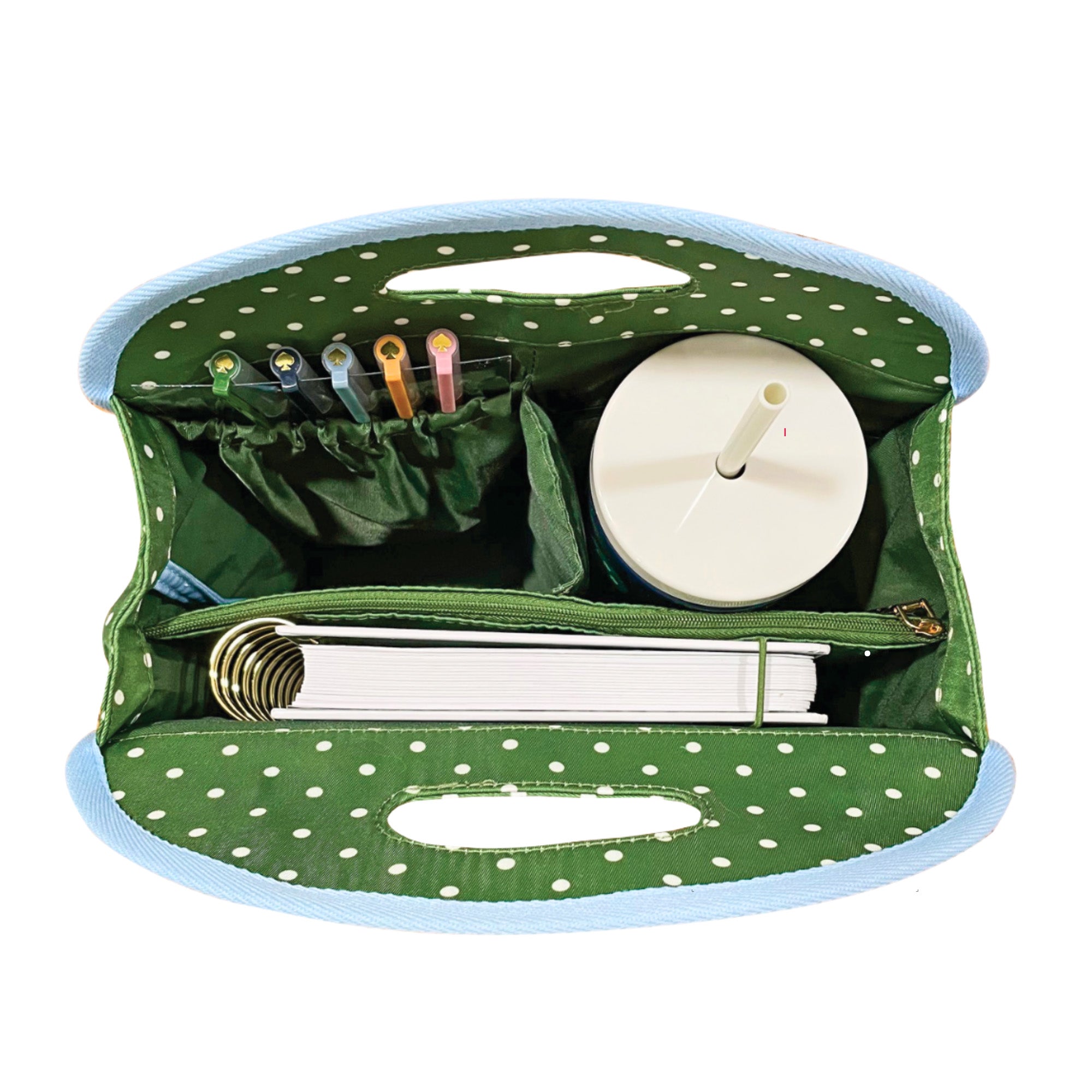interior of Green polka dot bag with blue trim on a white background