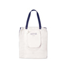 White tote bag with blue handles on a white background