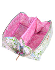 Floral-patterned bag with a pink interior on a white background