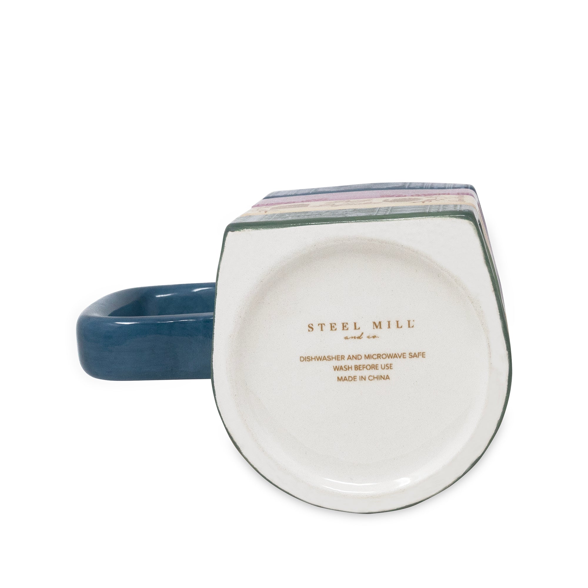 A ceramic mug shown from the bottom side, featuring a dark blue handle and a white interior printed with 'STEEL MILL' in gold text.