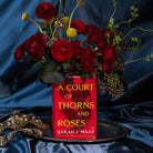 Book-shaped vase with 'A Court of Thorns and Roses' design with  bouquet inside