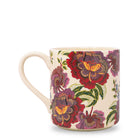 A ceramic mug with a cream-colored handle and base, decorated with a detailed floral pattern featuring red, purple, and green peony-like flowers with yellow centers on a white background.