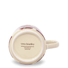 The bottom view of a ceramic mug showing the printed brand name 'vera bradley' on the cream-colored base, with a subtle floral pattern visible around the rim.