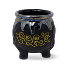 Black ceramic pot with yellow decorative pattern on a white background