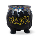 Black ceramic pot with yellow patterns and a colorful rim on a white background