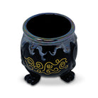 top view of black cauldron planter with oil slick bubbling top, gold swirl accents and three foot base