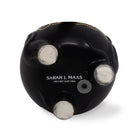 Black object with 'Sarah J. Maas' branding on a white background