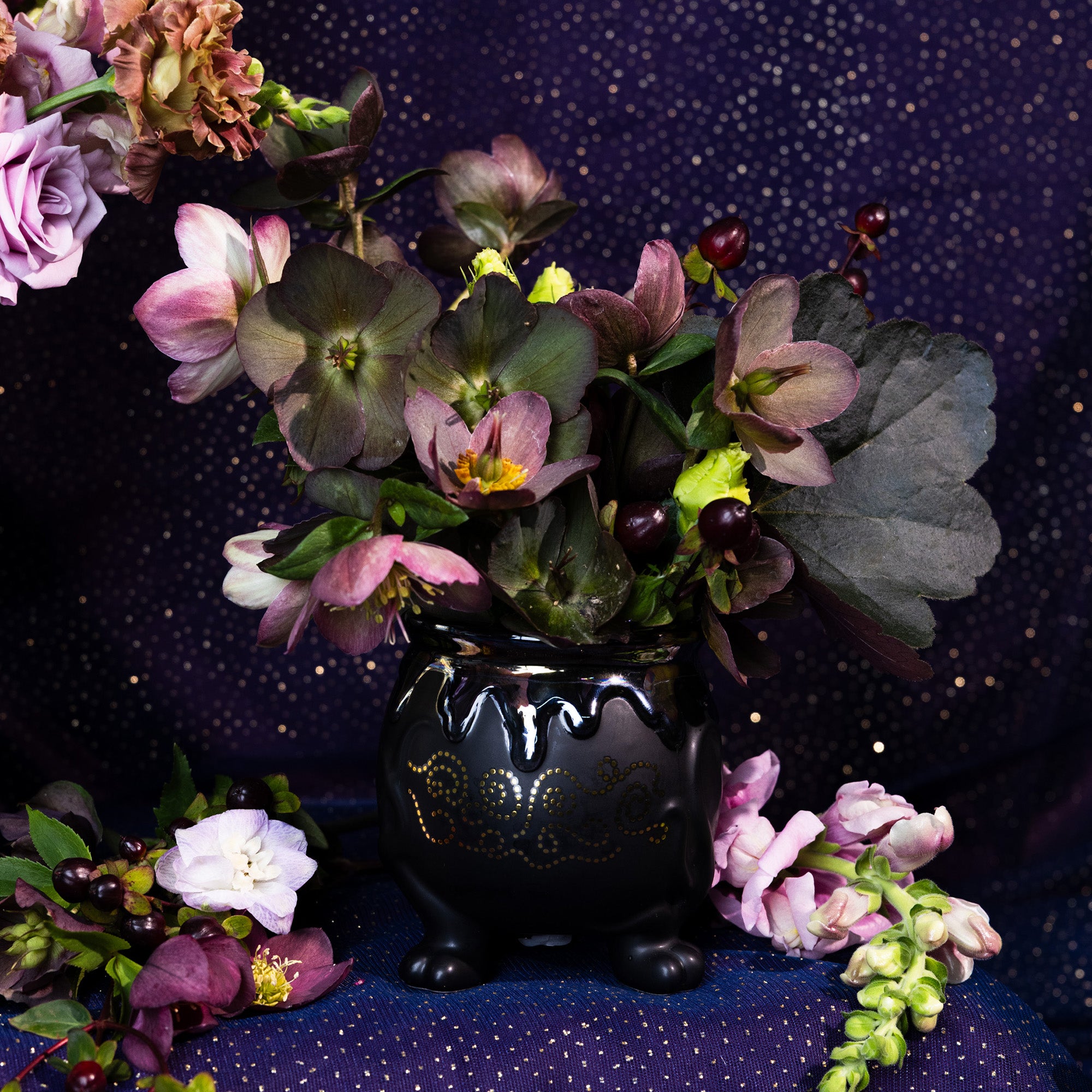 Black decorative pot with flowers inside