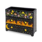 Black planter with floral and fiery designs on a white background