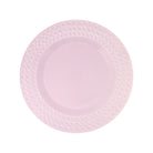 A light pink ceramic plate with a textured, embossed diamond pattern around the rim, shown from a top-down view on a white background.
