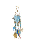 Decorative keychain with blue fish charm on a white background