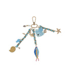 Keychain with various charms including fish and a starfish on a white background