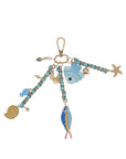 Keychain with various charms including fish and a starfish on a white background