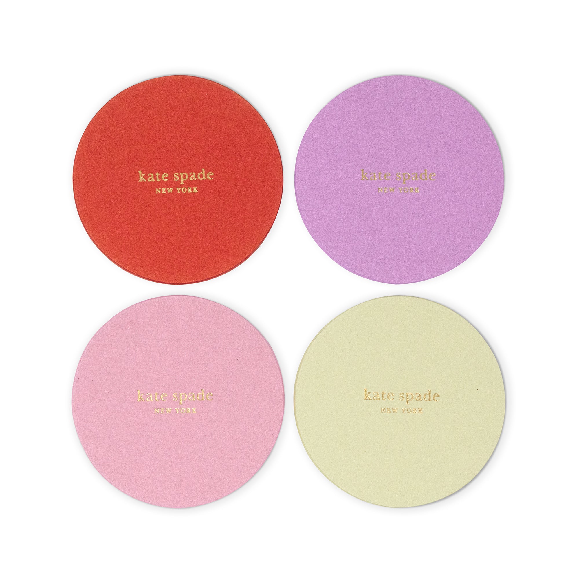 Four round Kate Spade coasters in red, purple, pink, and pale yellow, arranged in a 2x2 grid on a white background.