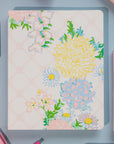Floral patterned notebook on a gray surface