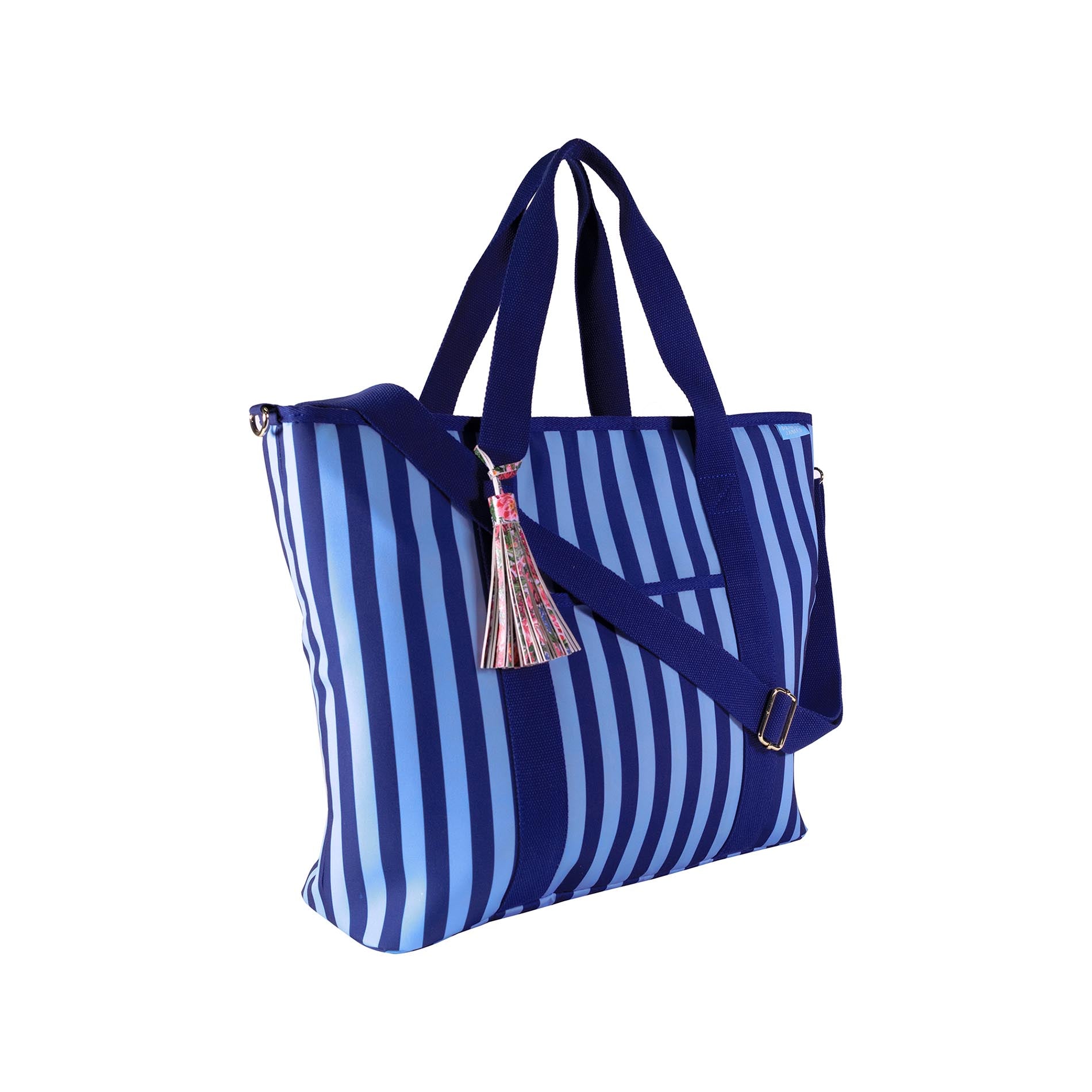Sideview of dark blue and light blue striped tote bag with a tassel on a white background