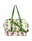 Floral-patterned bag with green straps on a white background