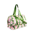 Floral patterned duffel bag with green handles on a white background