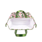 White interior of cooler bag with floral design and green handles on a white background