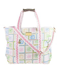 Patterned handbag with pink strap on a white background