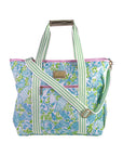 Patterned tote bag with green straps on a white background
