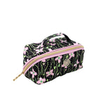 A rectangular cosmetic pouch with a black background, pink floral pattern, and green vine details, featuring a gold zipper and a top handle.