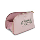 Pink toiletry bag with 'KEEPING IT TOGETHER' text on a white background