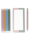 Set of colorful pens, a striped notepad, and a pink pen on a white background