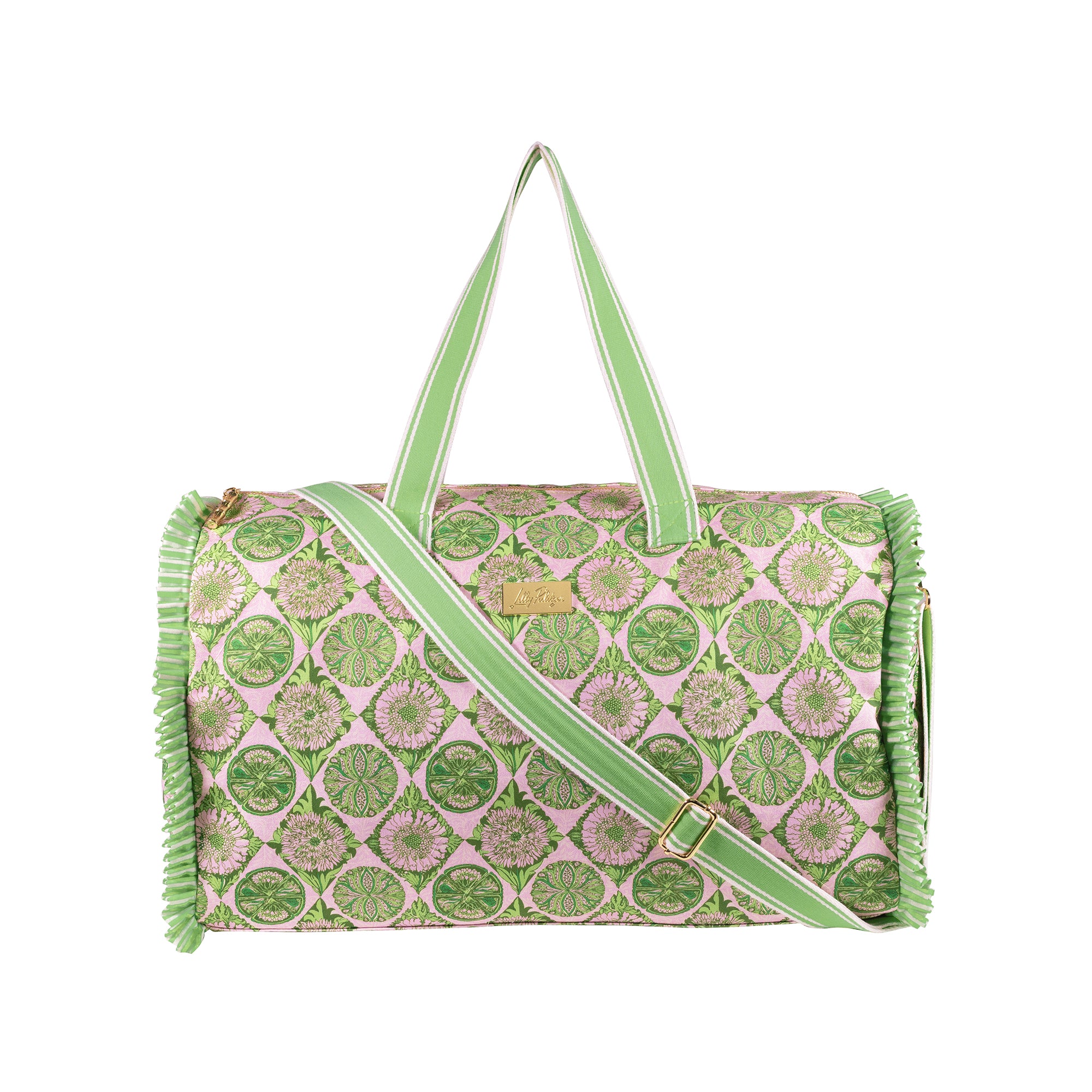 A cylindrical duffel bag with a pink and green circular pattern, featuring light green handles and strap, gold-tone hardware, and fringed edges on a white background.