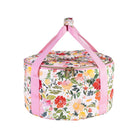 Floral-patterned dutch over carrier with pink handle on a white background
