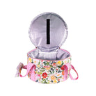 Opened Floral-patterned dutch over carrier with pink handle on a white background