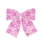 Pink floral bow on a white background