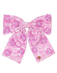 Pink floral bow on a white background