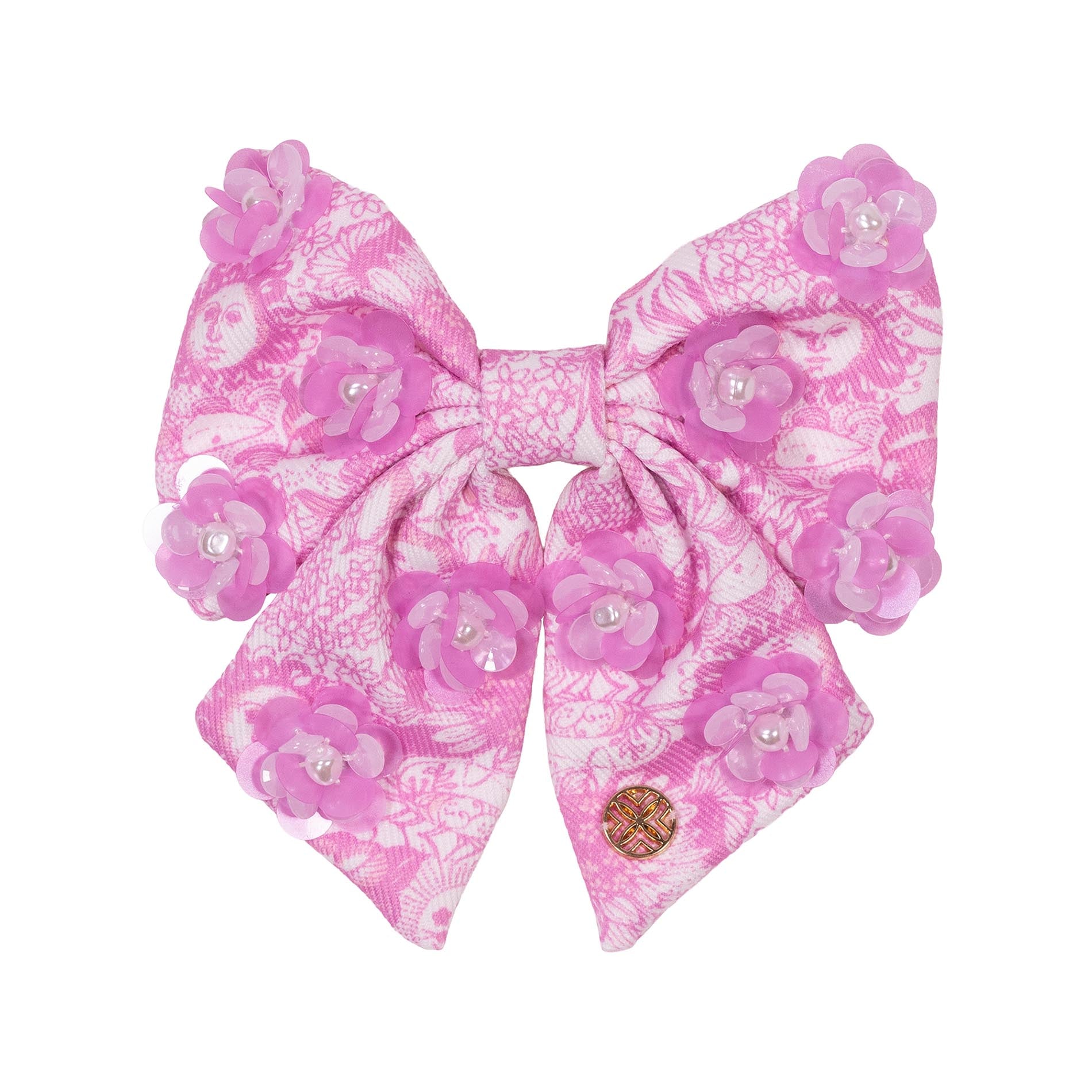 Pink floral hair bow with pearl accents on a white background