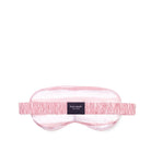 Pink sleep mask with 'kate spade' label on a white background