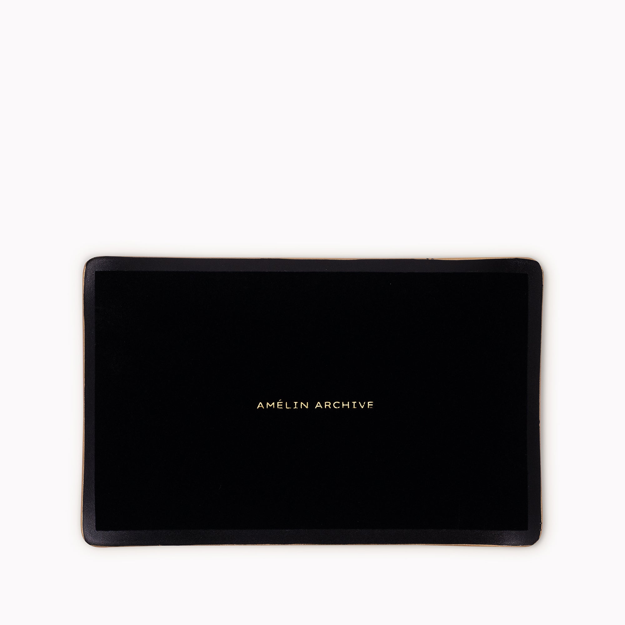 A black rectangular tray with a gold metallic border and the text 'AMELIN ARCHIVE' printed in gold at the center, shown against a plain white background.