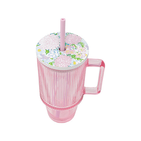 Pink cup with floral lid and straw on a white background