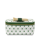 Polka dot makeup bag with hair clips on a white background