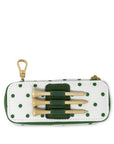 Polka dot case with golf tees and a gold clip on a white background