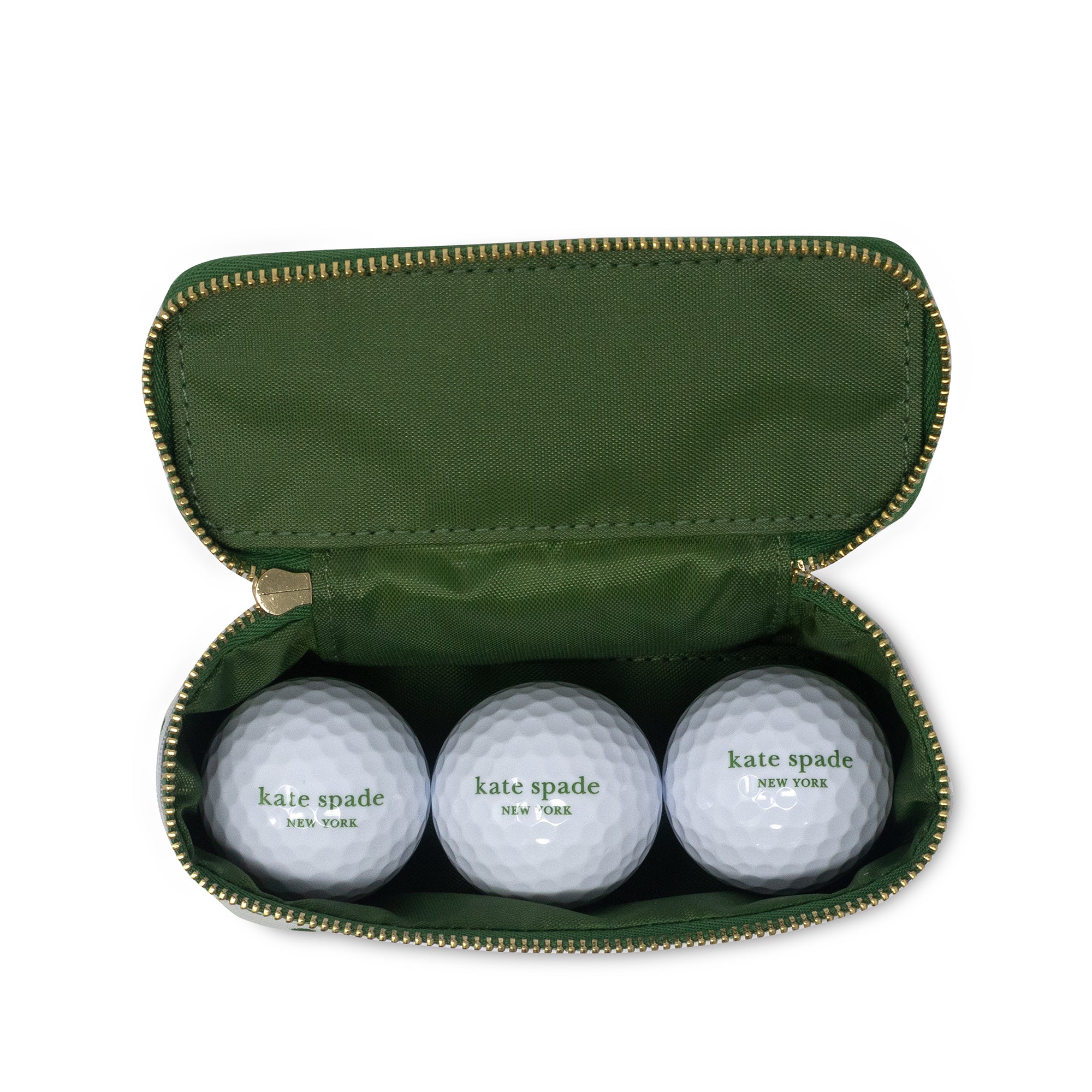 Three golf balls with 'kate spade new york' branding in a green case.