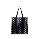 Black tote bag with white polka dot pattern on a white background
